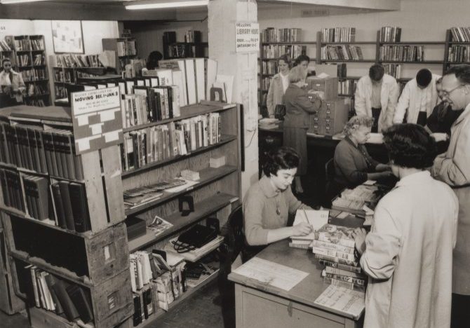 People getting their books checked out by staff at the Bellevue library (vintage)